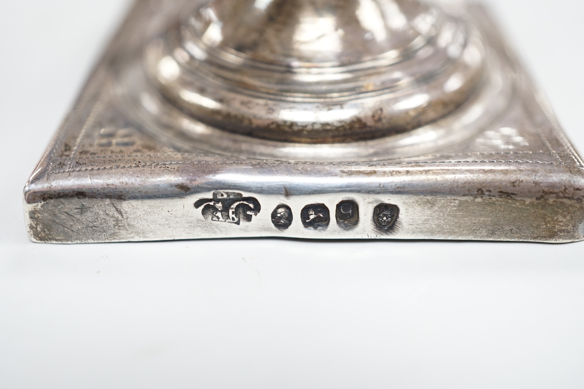 A George III silver helmet shaped cream jug, on square base, London, 1791 (overstruck maker's mark), 14.3 cm(a.f.) and a George II silver pepperette, London, 1755, (a.f.), 5.4oz.